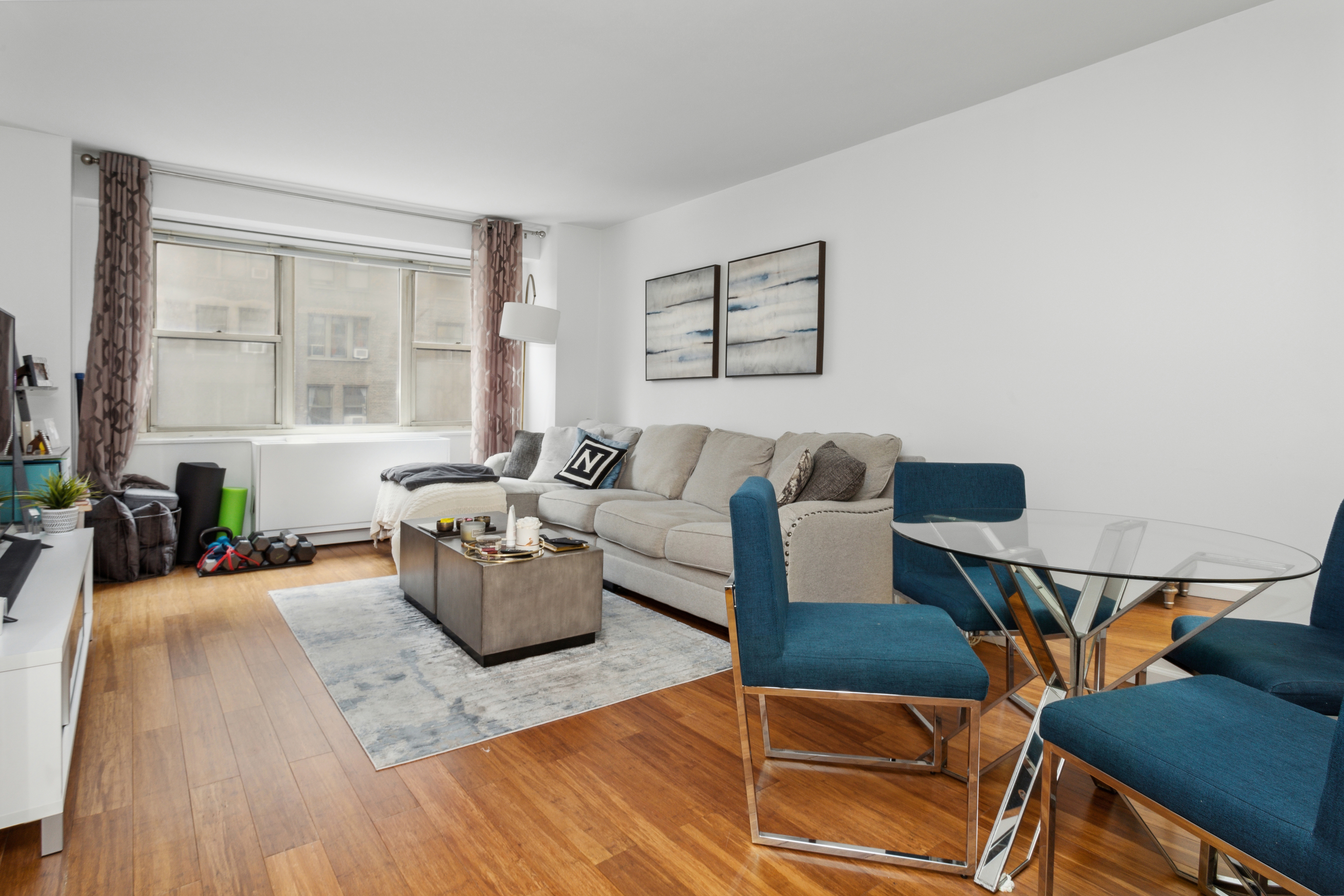 400 East 54th Street, Unit 7D Manhattan, NY 10022 - Photo 1 of 6 a living room with furniture and wooden floor