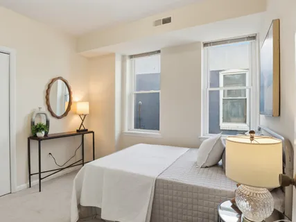 a bedroom with bed and a window