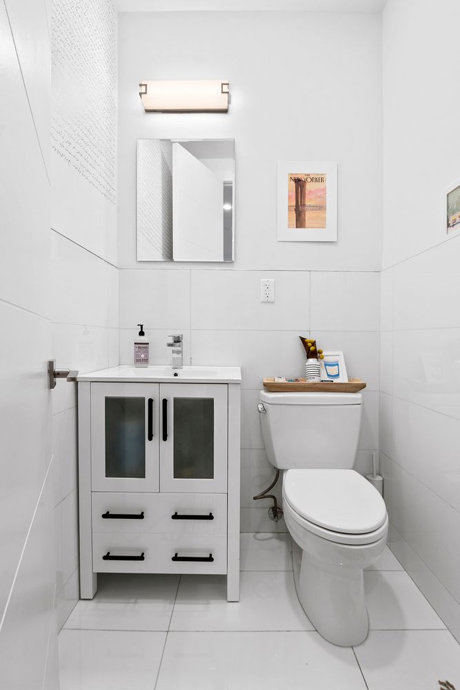 296 Fenimore Street Brooklyn, NY 11225 - Photo 17 of 19 a bathroom with a toilet sink and mirror