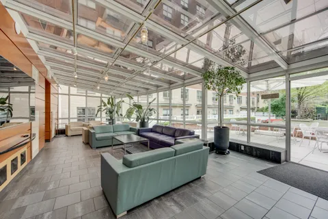 a living room with furniture and a floor to ceiling window