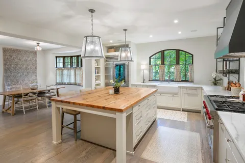 a kitchen with stainless steel appliances granite countertop a stove and a wooden floors