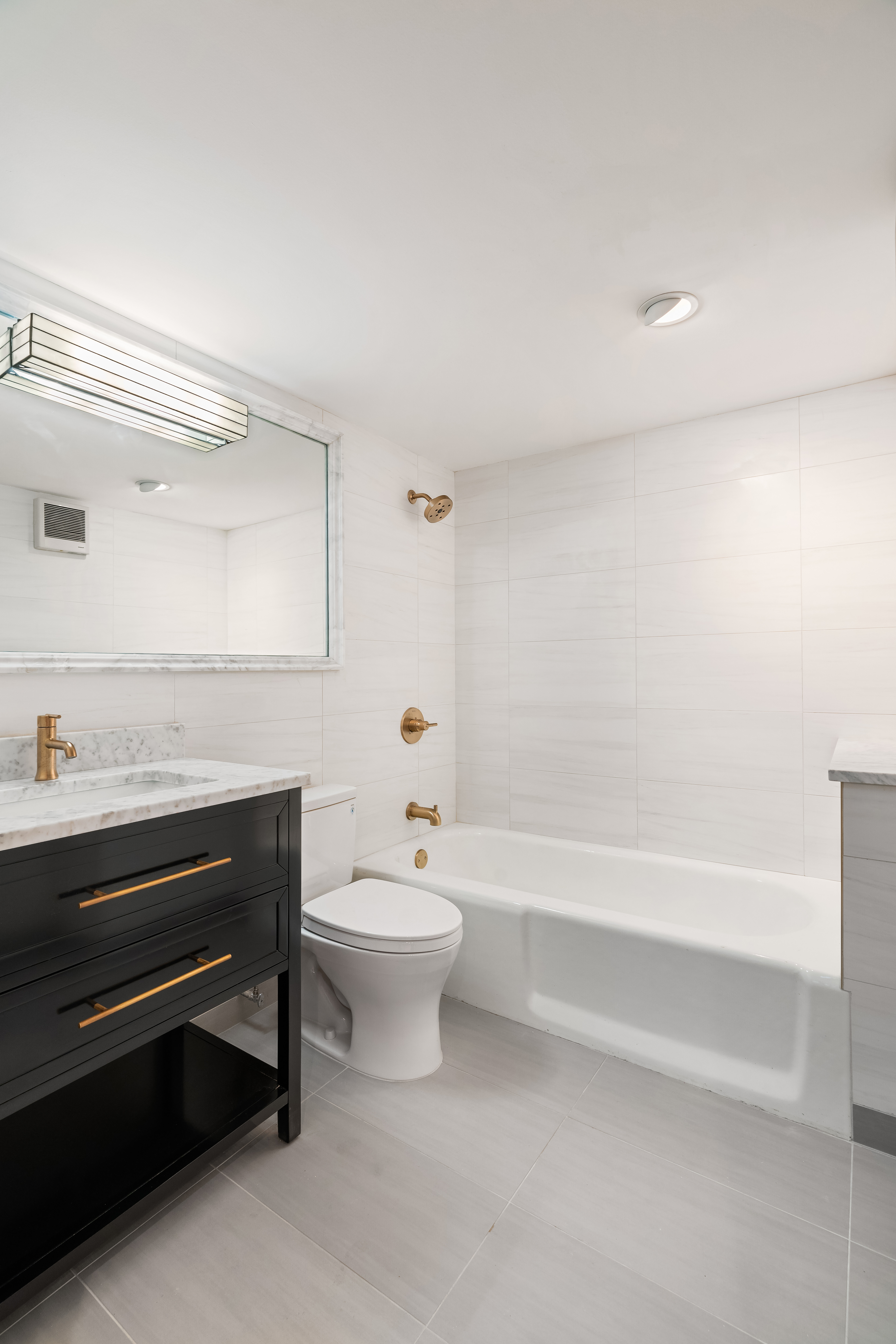 51 East 10th Street, Unit 9 Manhattan, NY 10003 - Photo 3 of 9 a bathroom with a toilet a sink and bathtub