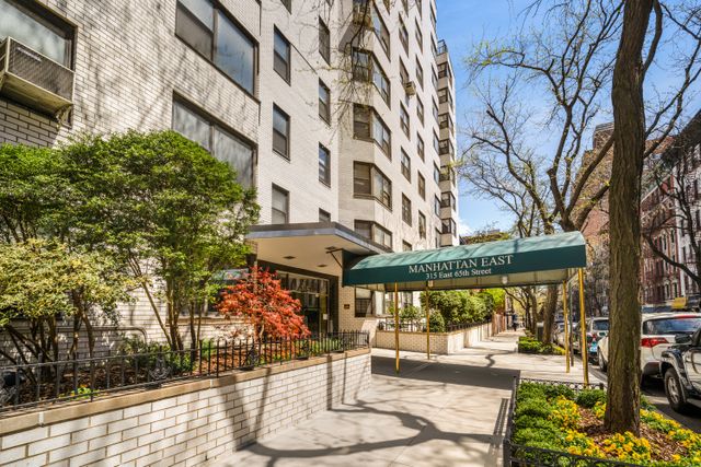 315 East 65th Street, Unit 1A Manhattan, NY 10065 - Photo 7 of 12 a view of a building with a bench in patio