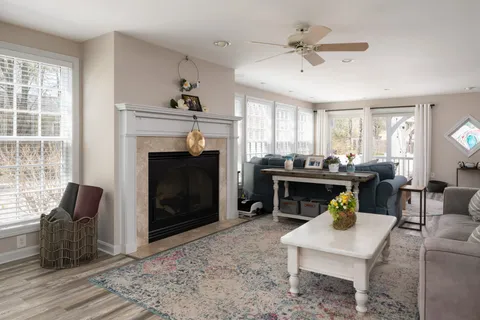 a living room with furniture fireplace and window