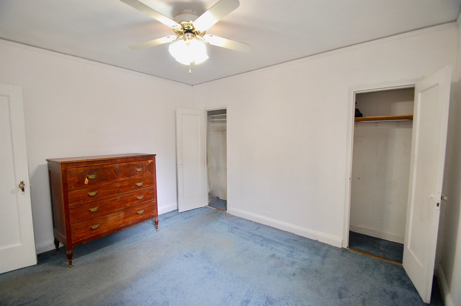 43-10 48th Avenue, Unit 2P Queens, NY 11377 - Photo 4 of 9 an empty room with closet and a ceiling fan