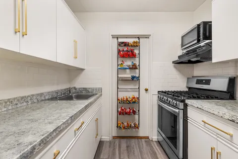 a kitchen with stainless steel appliances granite countertop a stove and a sink