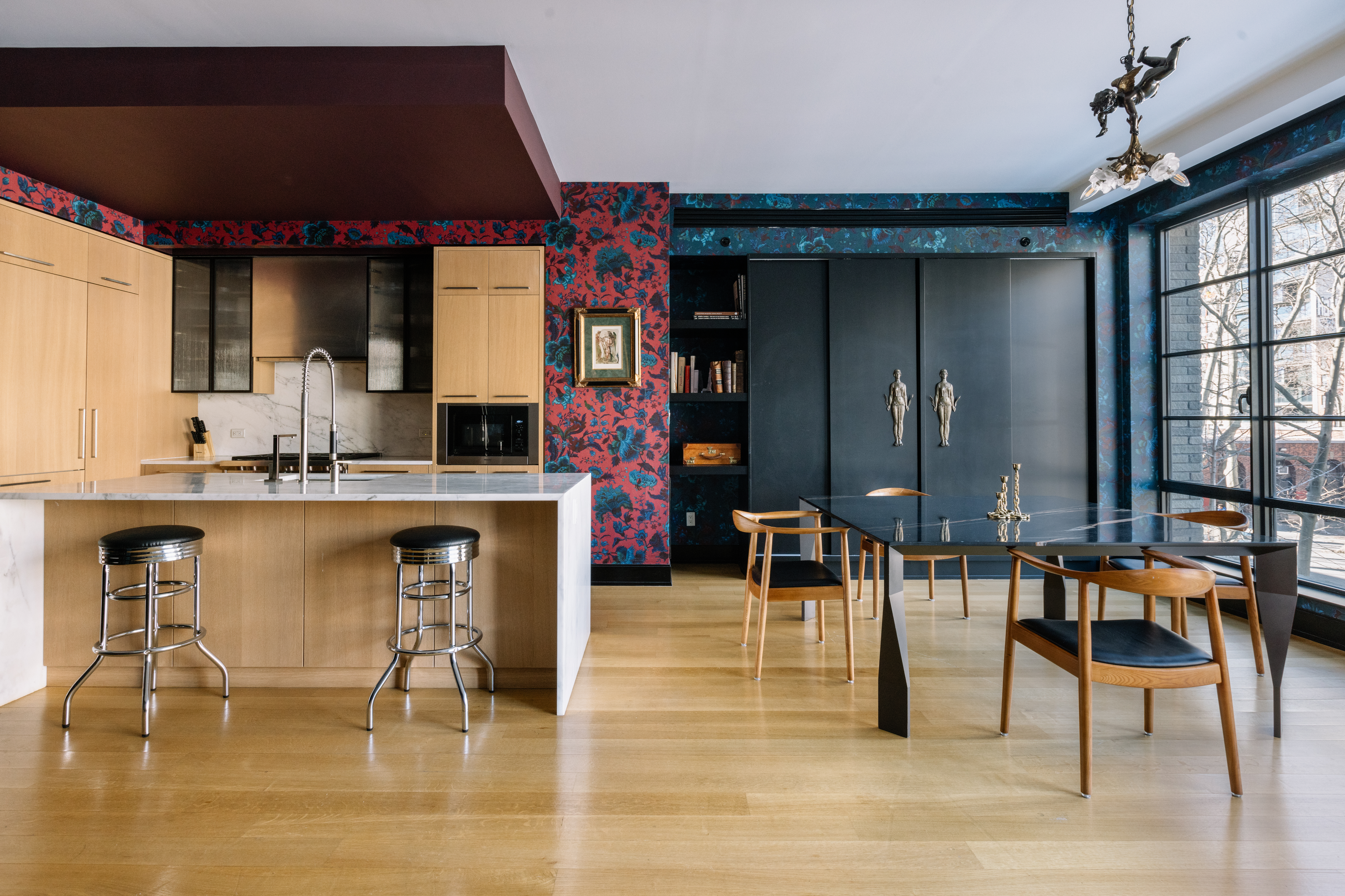 a kitchen with lots of counter and chairs
