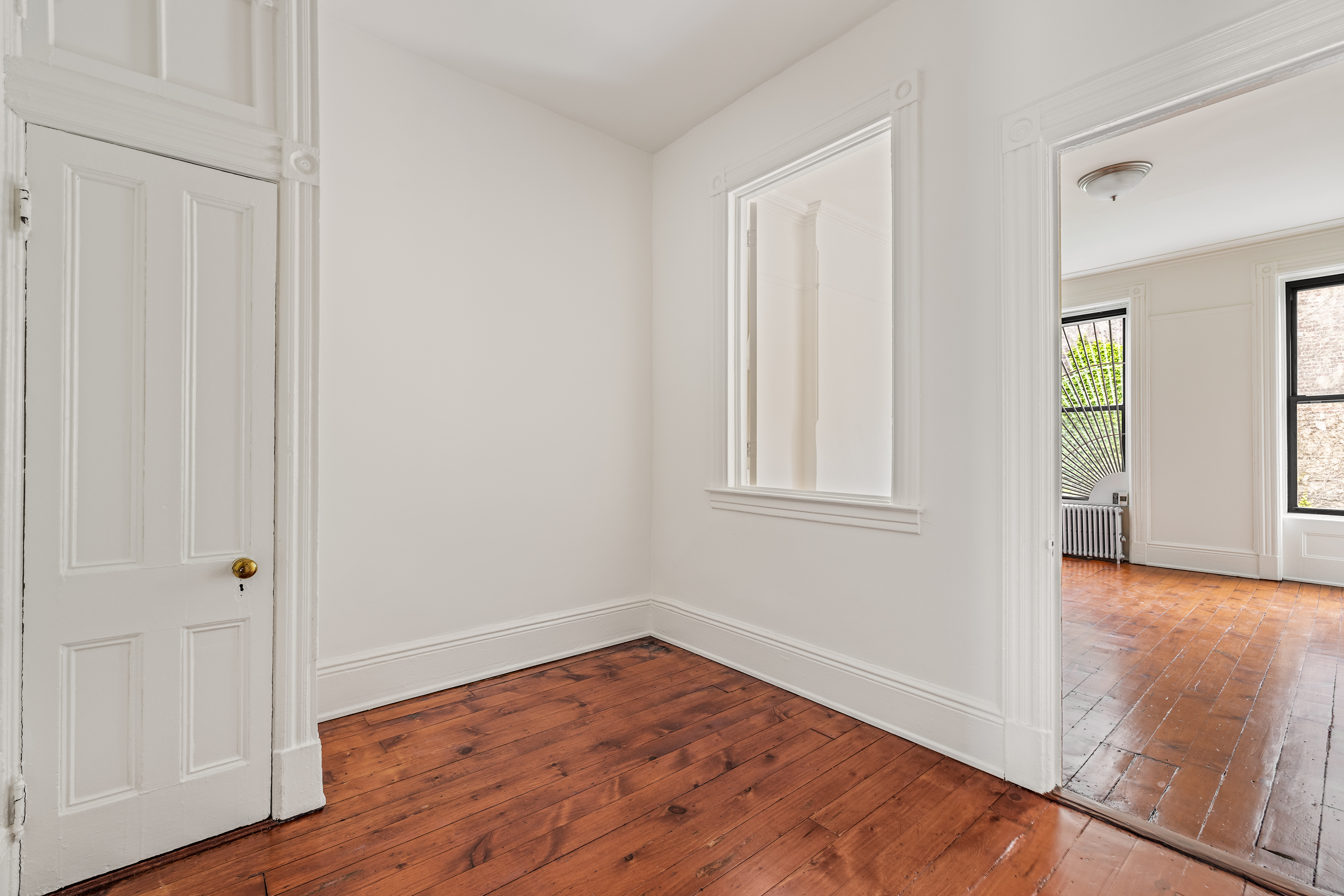 353 7th Avenue, Unit 1 Brooklyn, NY 11215 - Photo 4 of 8 an empty room with wooden floor and windows