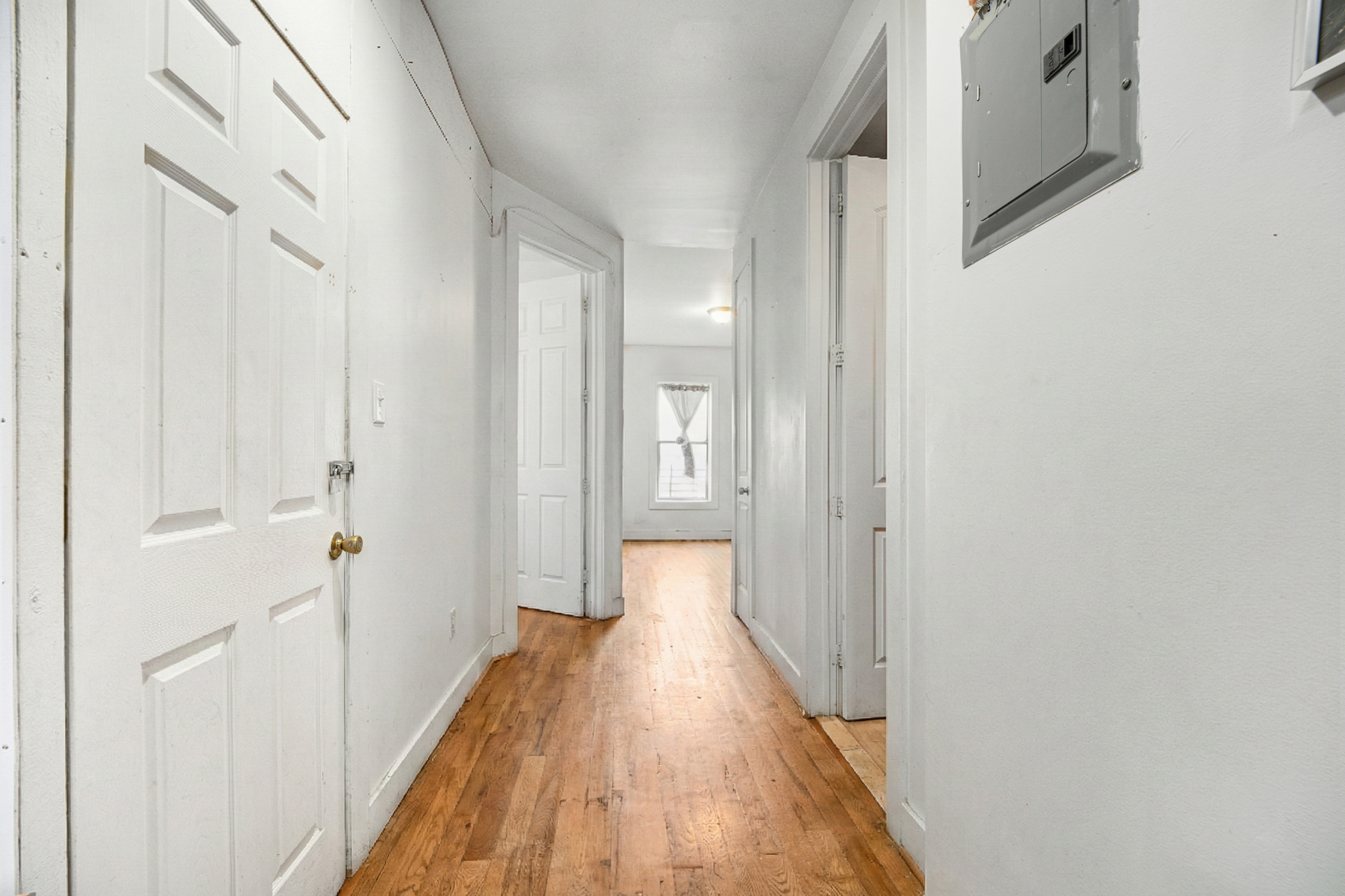 62-22 Myrtle Avenue Queens, NY 11385 - Photo 5 of 13 a view of a hallway with wooden floor and staircase