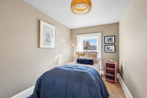 a bedroom with a bed and a lamp