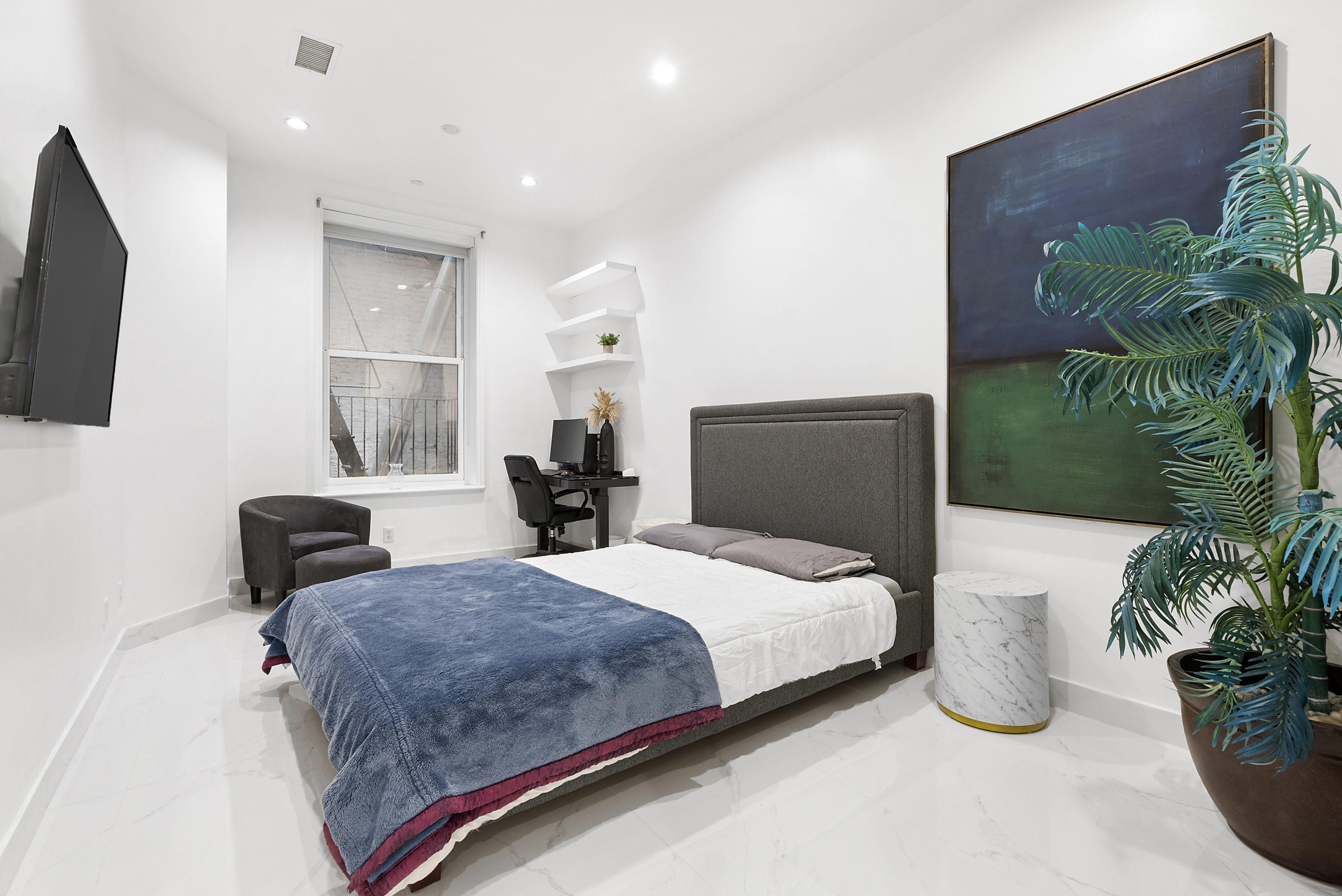 53 Murray Street, Unit 1 Manhattan, NY 10007 - Photo 9 of 15 a bedroom with a bed and a potted plant