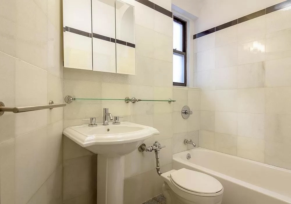90 Thompson Street, Unit A2 Manhattan, NY 10012 - Photo 5 of 6 a bathroom with a sink a toilet and shower