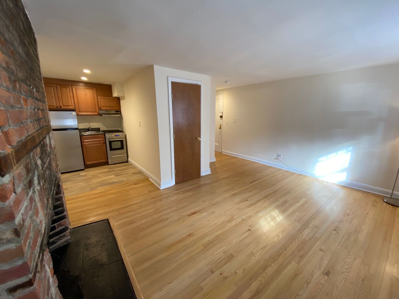754 Greenwich Street, Unit 1A Manhattan, NY 10014 - Photo 4 of 6 a view of a kitchen with wooden floor and electronic appliances