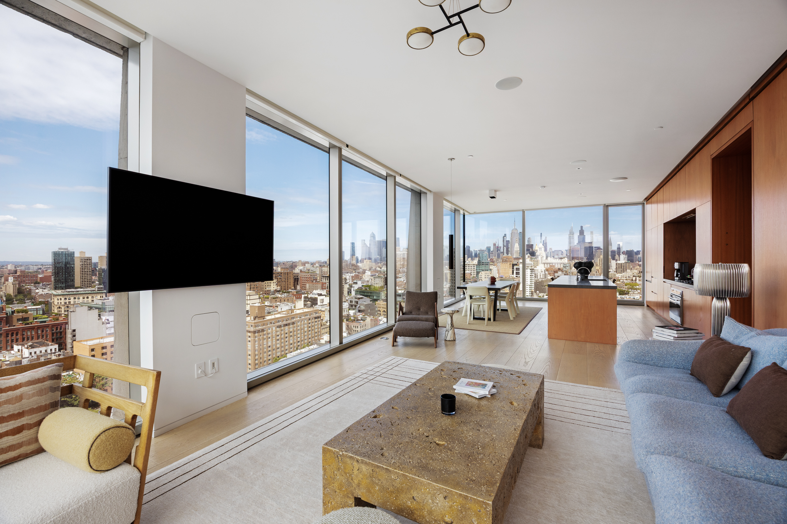 215 Chrystie Street, Unit 29W Manhattan, NY 10002 - Photo 2 of 24 a living room with furniture and a flat screen tv