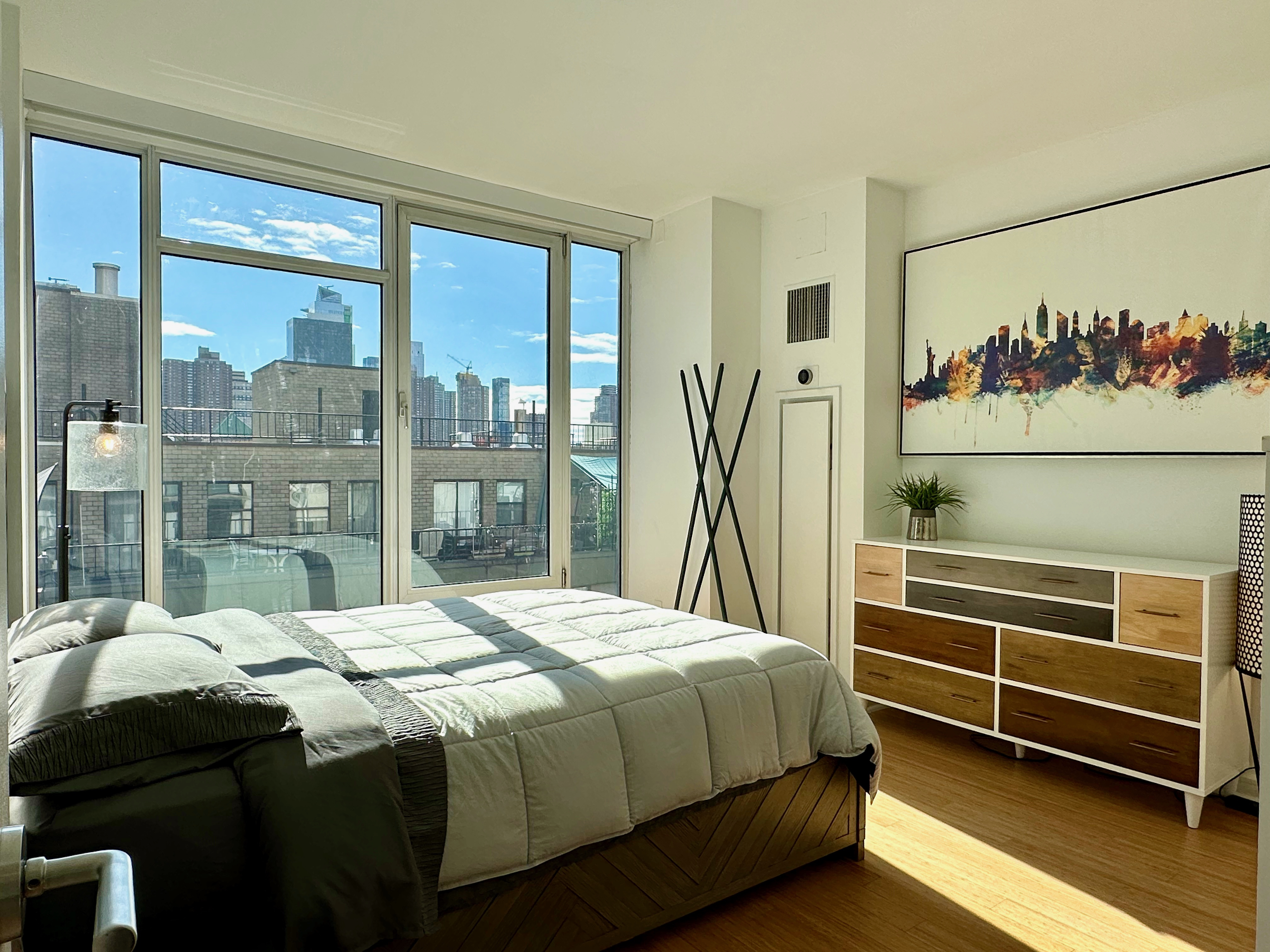 350 West 53rd Street, Unit PHA Manhattan, NY 10019 - Photo 17 of 35 a bedroom with a bed and a large window