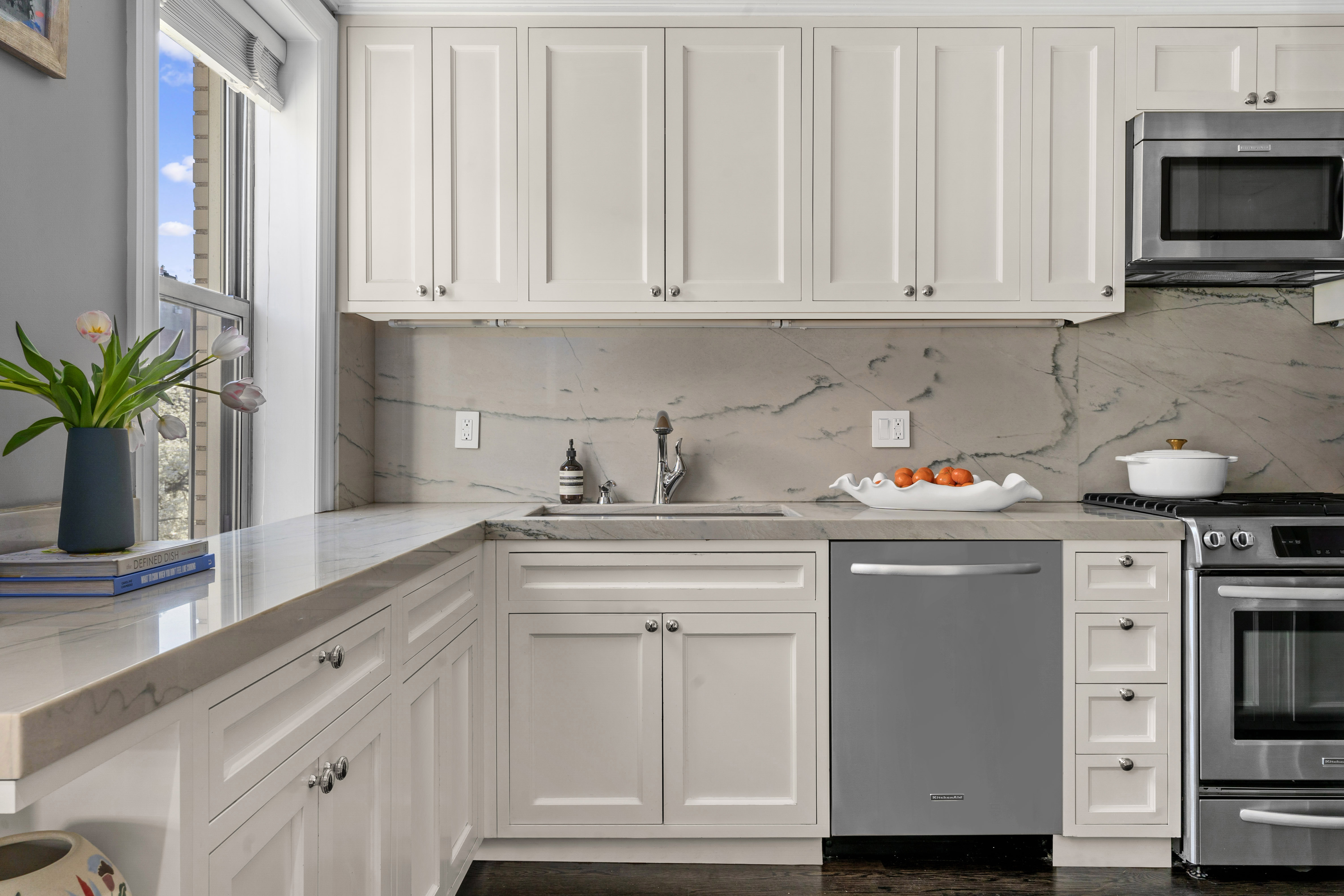 75 Bank Street, Unit 3K Manhattan, NY 10014 - Photo 4 of 11 a kitchen with white cabinets and a stove