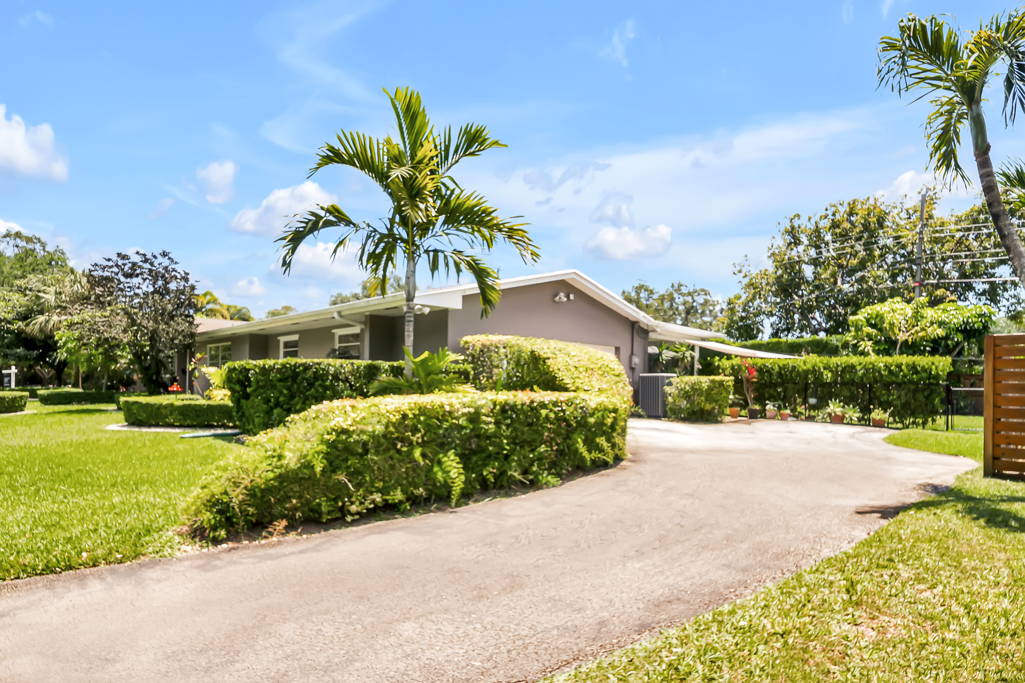 6760 Southwest 62nd Terrace Miami, FL 33143 - Photo 11 of 38 a front view of a house with a yard and garage