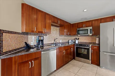 a kitchen with a sink and wooden cabinets