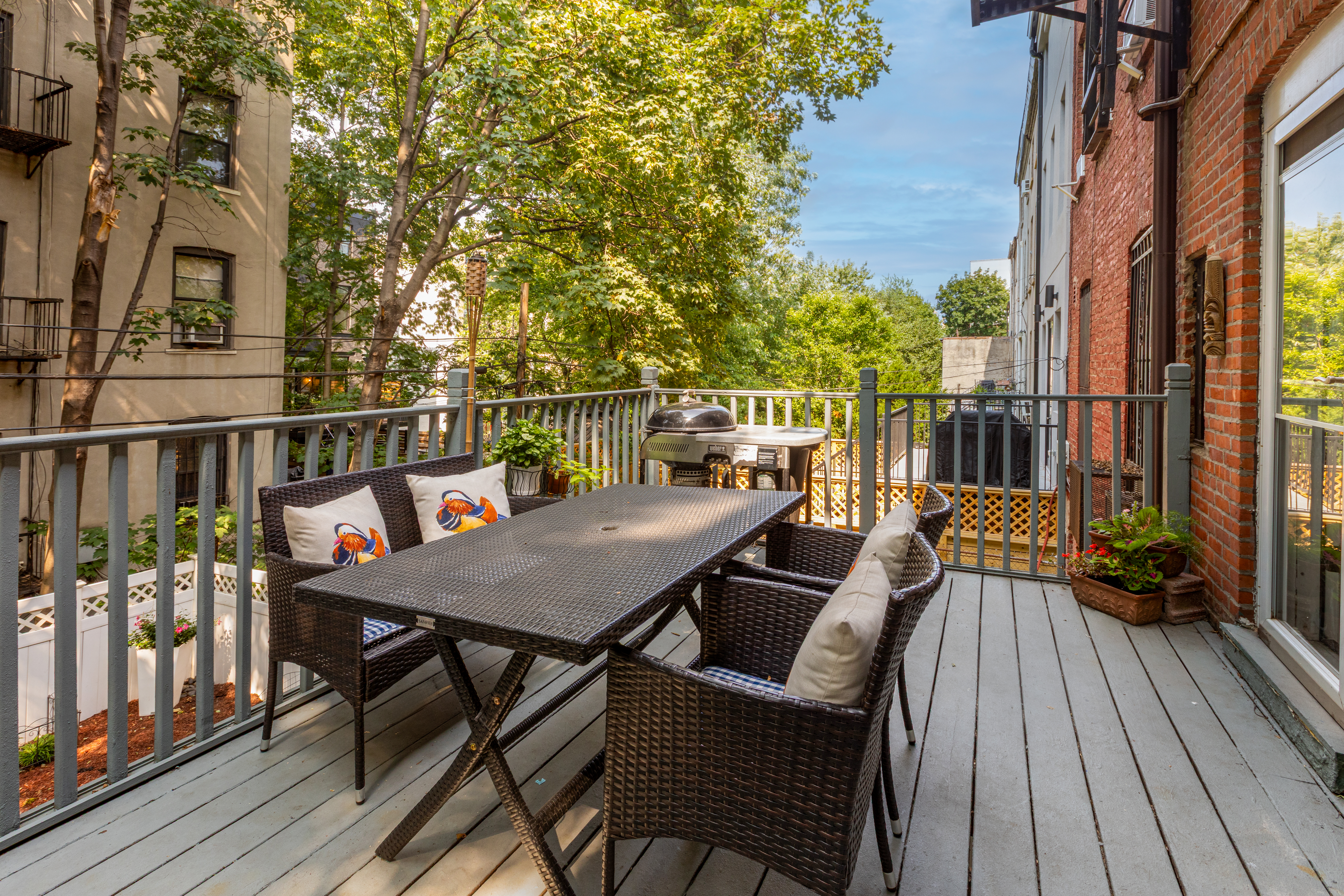 73 Monroe Street Brooklyn, NY 11216 - Photo 4 of 14 a balcony with wooden floor table and chairs