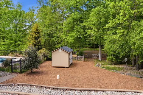 a backyard of a house with table and chairs