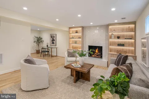 a living room with furniture a fireplace and a flat screen tv