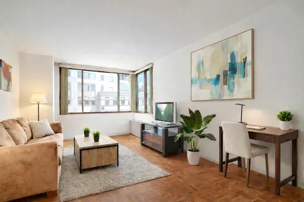 a living room with furniture and wooden floor