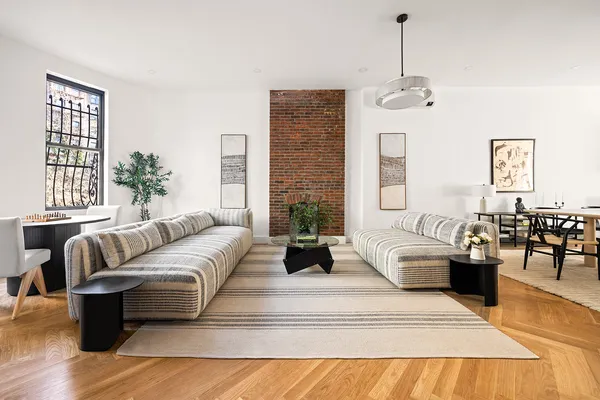 a living room with furniture potted plant and a chandelier