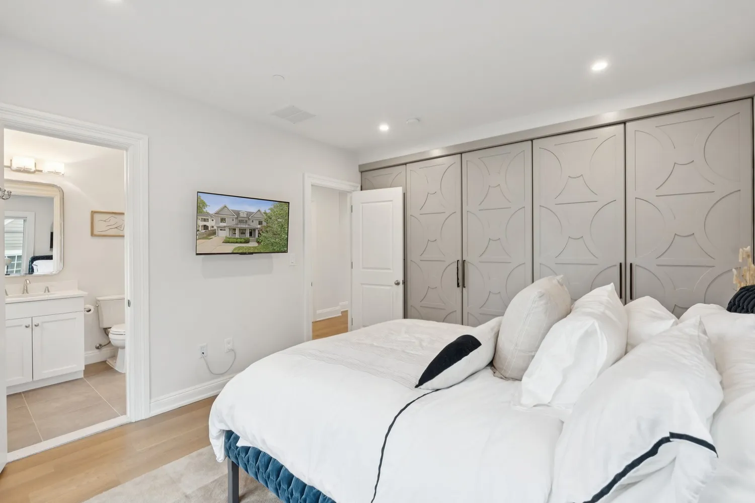 a bedroom with a large bed and a large mirror