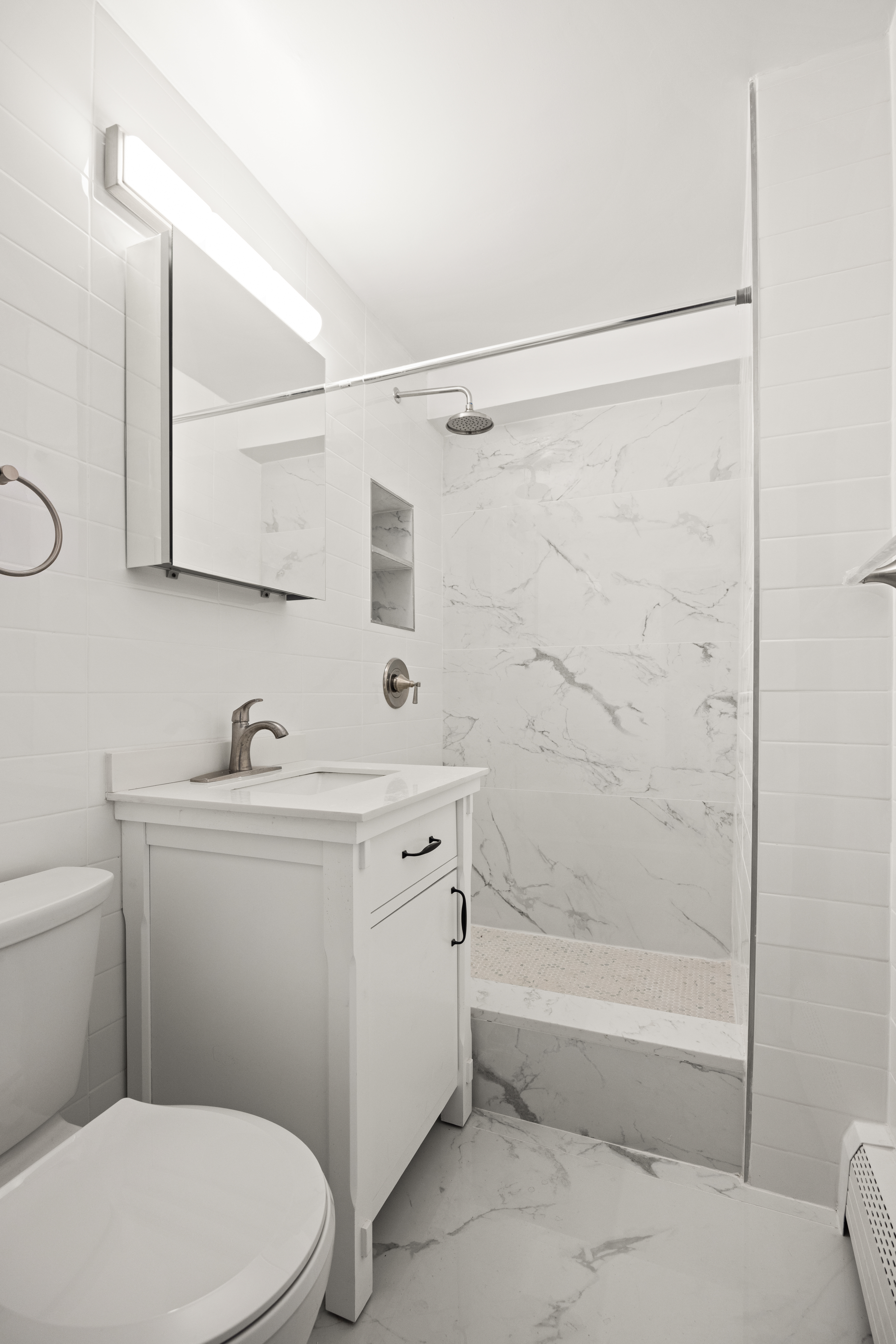 135 Ocean Parkway, Unit 9M Brooklyn, NY 11218 - Photo 10 of 18 a bathroom with a sink a toilet and shower