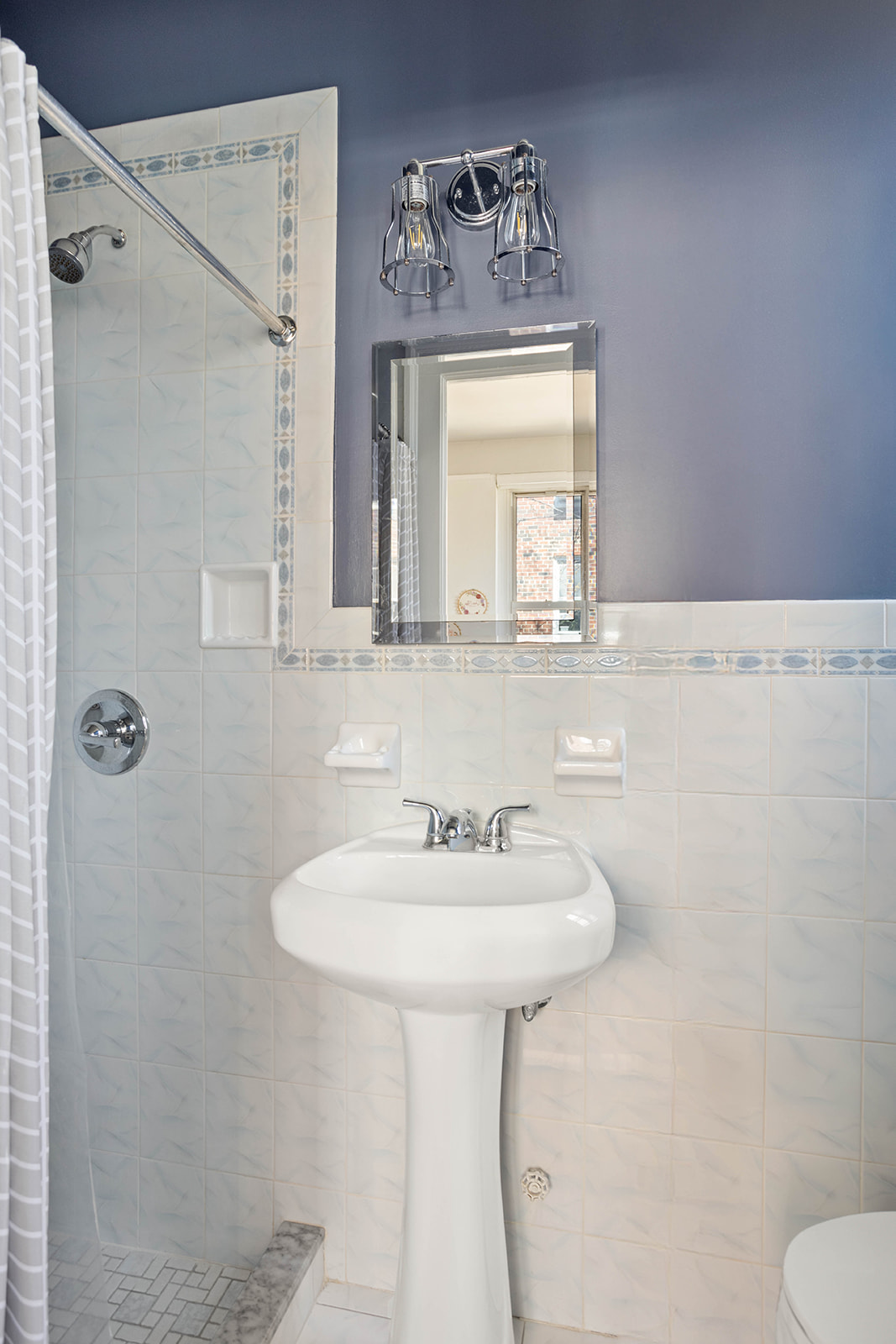 34-28 80th Street, Unit 41 Queens, NY 11372 - Photo 12 of 15 a bathroom with a sink a mirror and a toilet