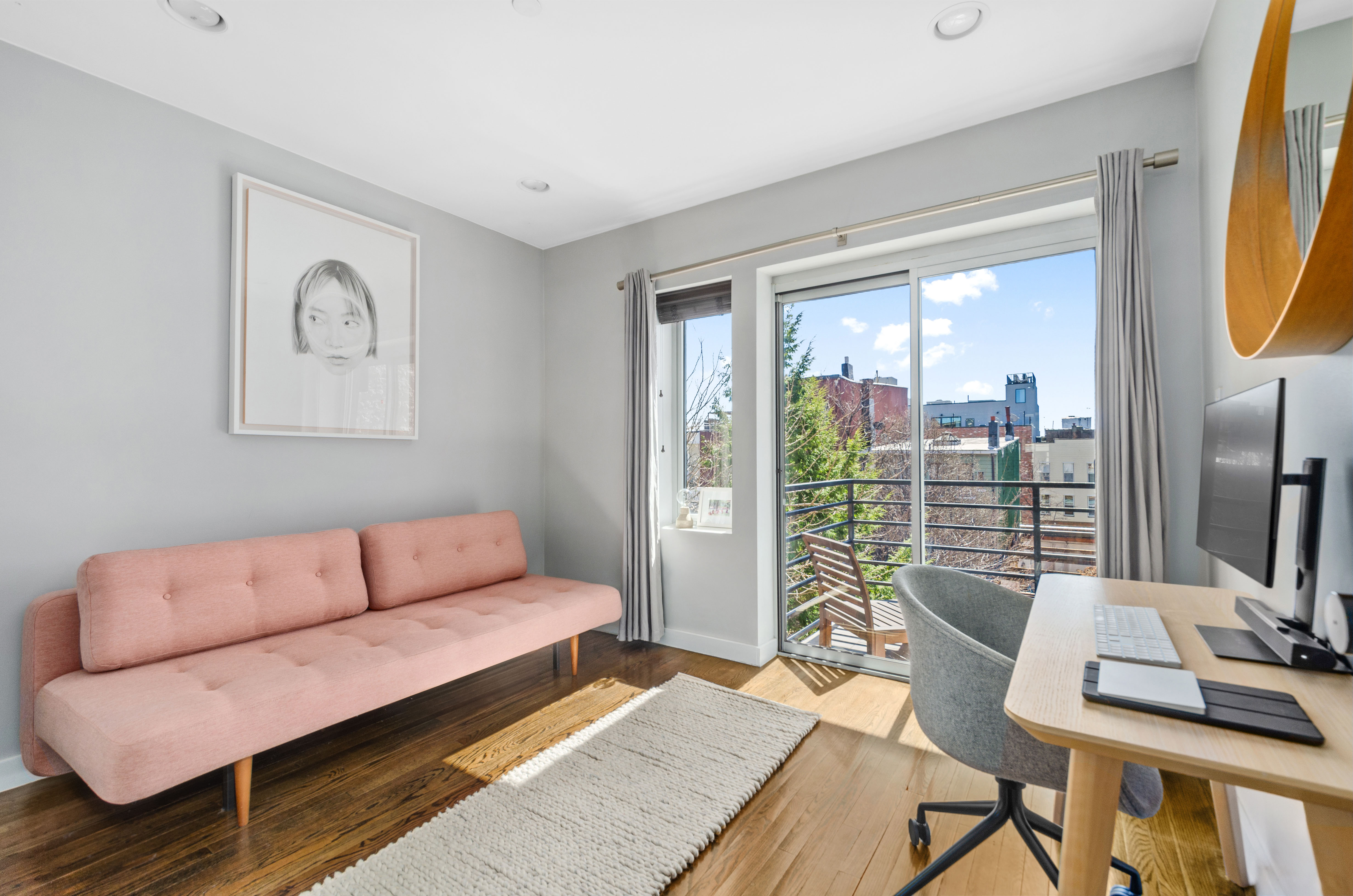 48 Box Street, Unit 5 Brooklyn, NY 11222 - Photo 6 of 10 a living room with furniture and a flat screen tv