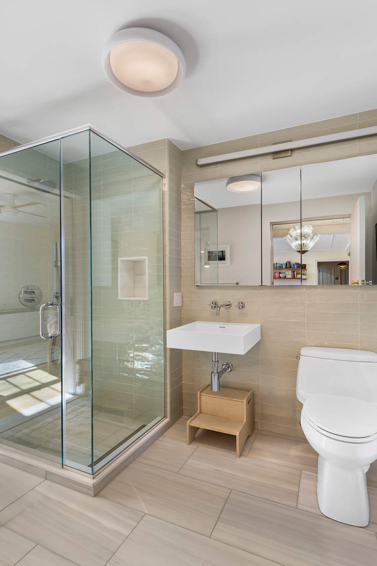 47 Plaza Street West, Unit 5B Brooklyn, NY 11217 - Photo 9 of 14 a bathroom with a double vanity sink toilet and shower