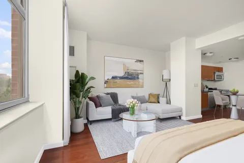 a bedroom with two beds and a potted plant