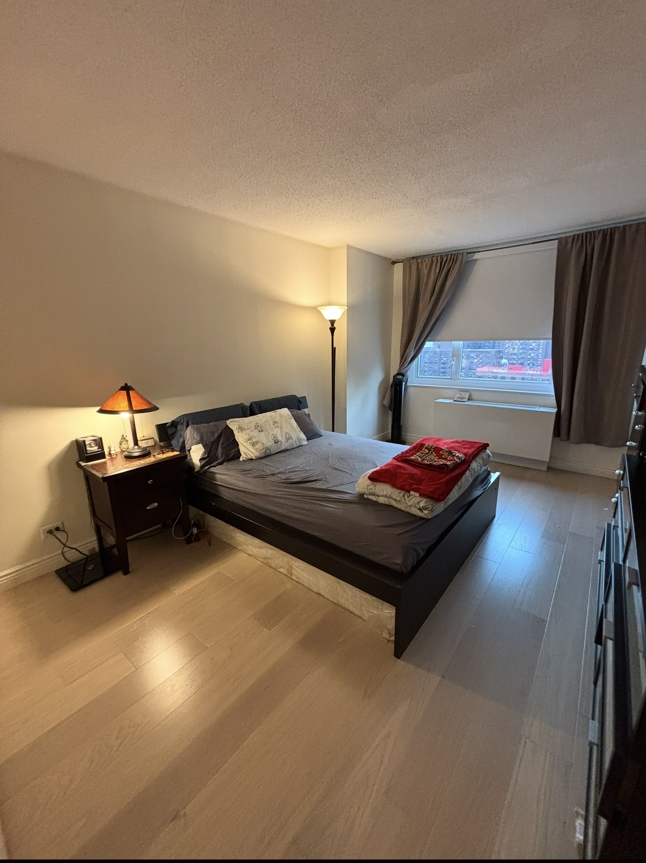 215 East 95th Street, Unit 19G Manhattan, NY 10128 - Photo 11 of 14 a living room with furniture gym equipment and a flat screen tv