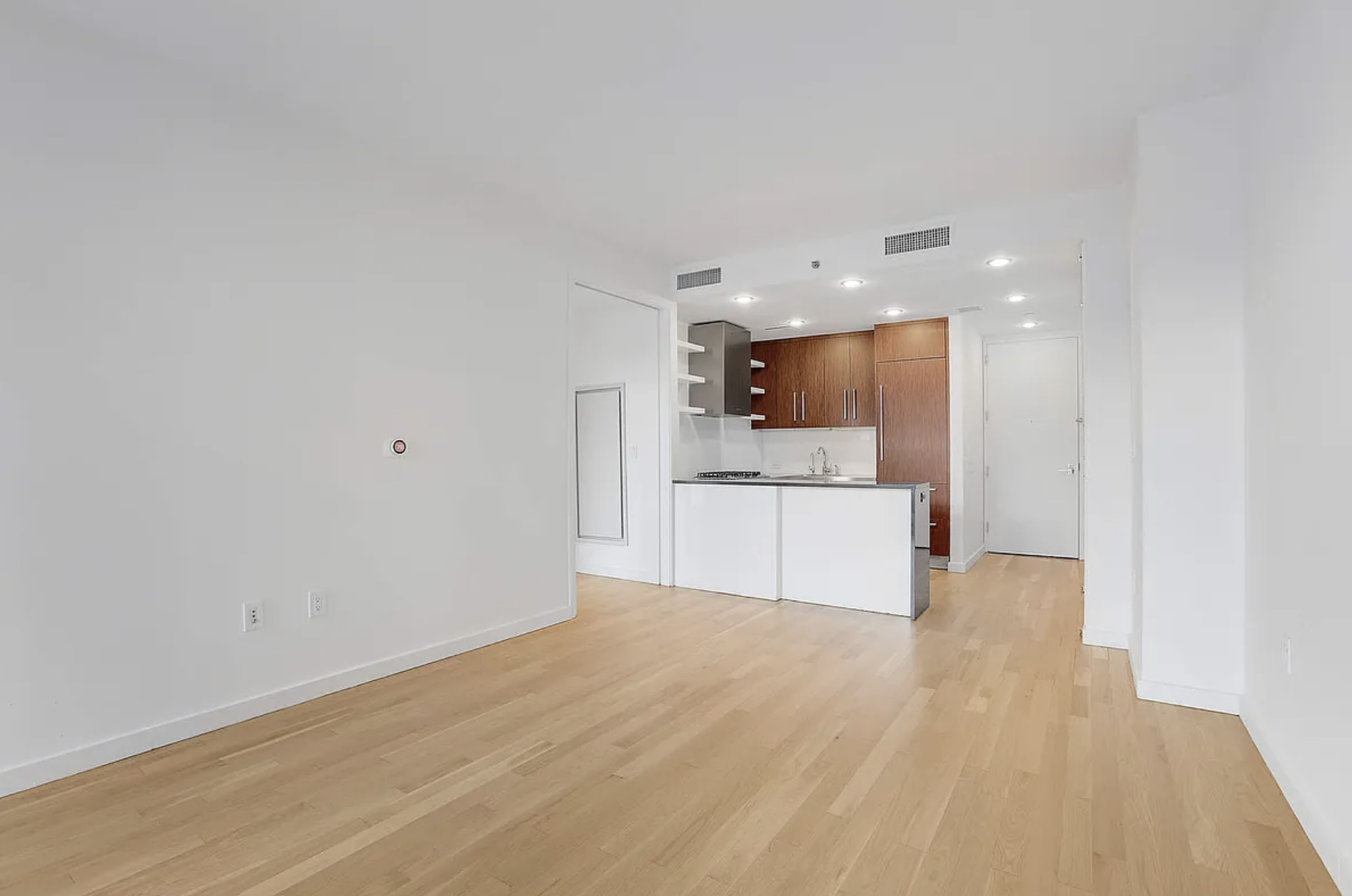 133 West 22nd Street, Unit 7H Manhattan, NY 10011 - Photo 4 of 22 a view of kitchen with wooden floor