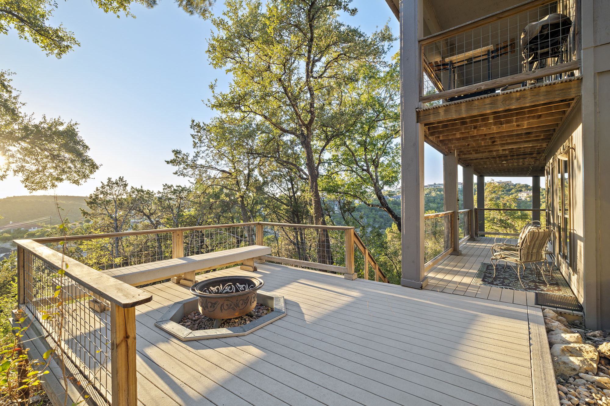 1605 The High Road Austin, TX 78746 - Photo 20 of 45 a view of a balcony with wooden floor and outdoor seating