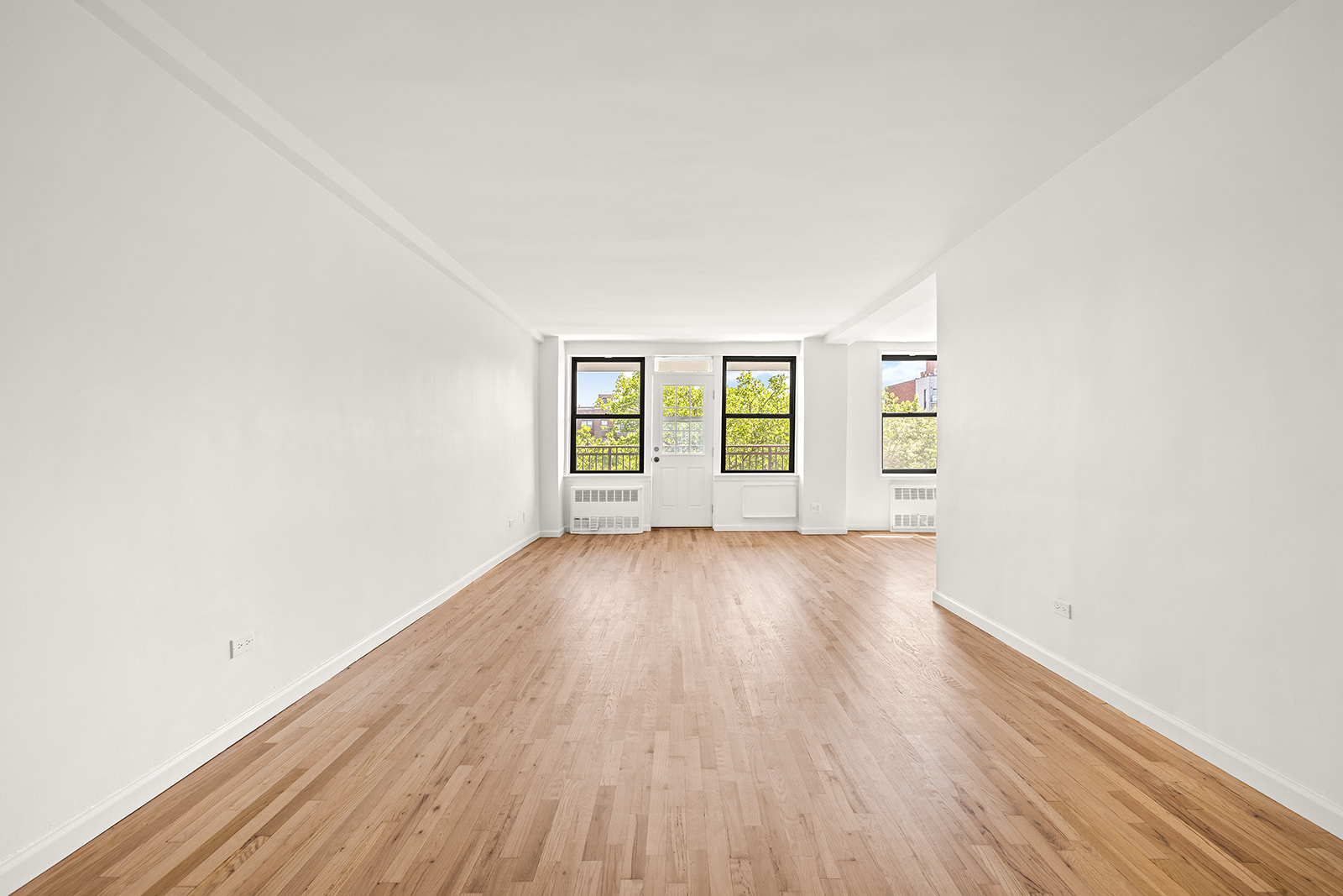 540 Ocean Parkway, Unit 5R Brooklyn, NY 11218 - Photo 2 of 11 an empty room with wooden floor and windows