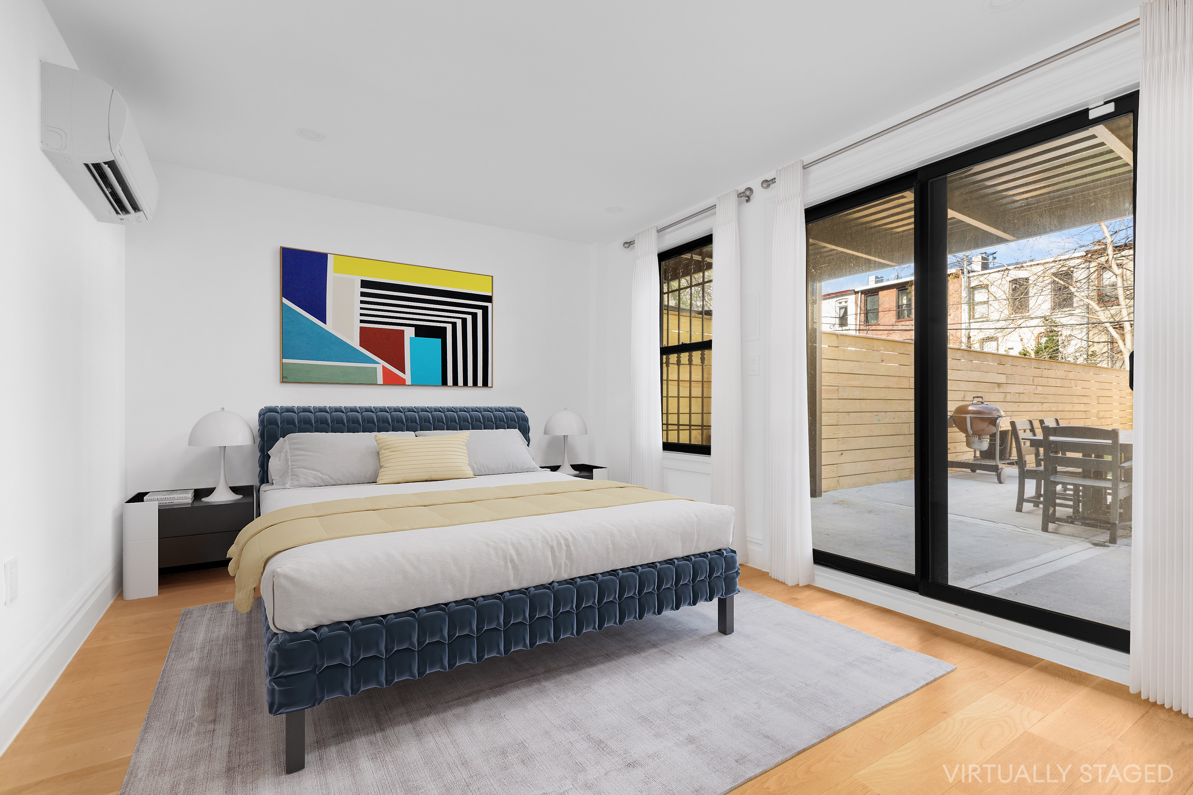 527 Quincy Street, Unit 1 Brooklyn, NY 11221 - Photo 4 of 8 a bedroom with a large bed and a large window