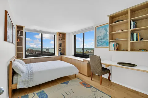 a bedroom with a large bed and a large window