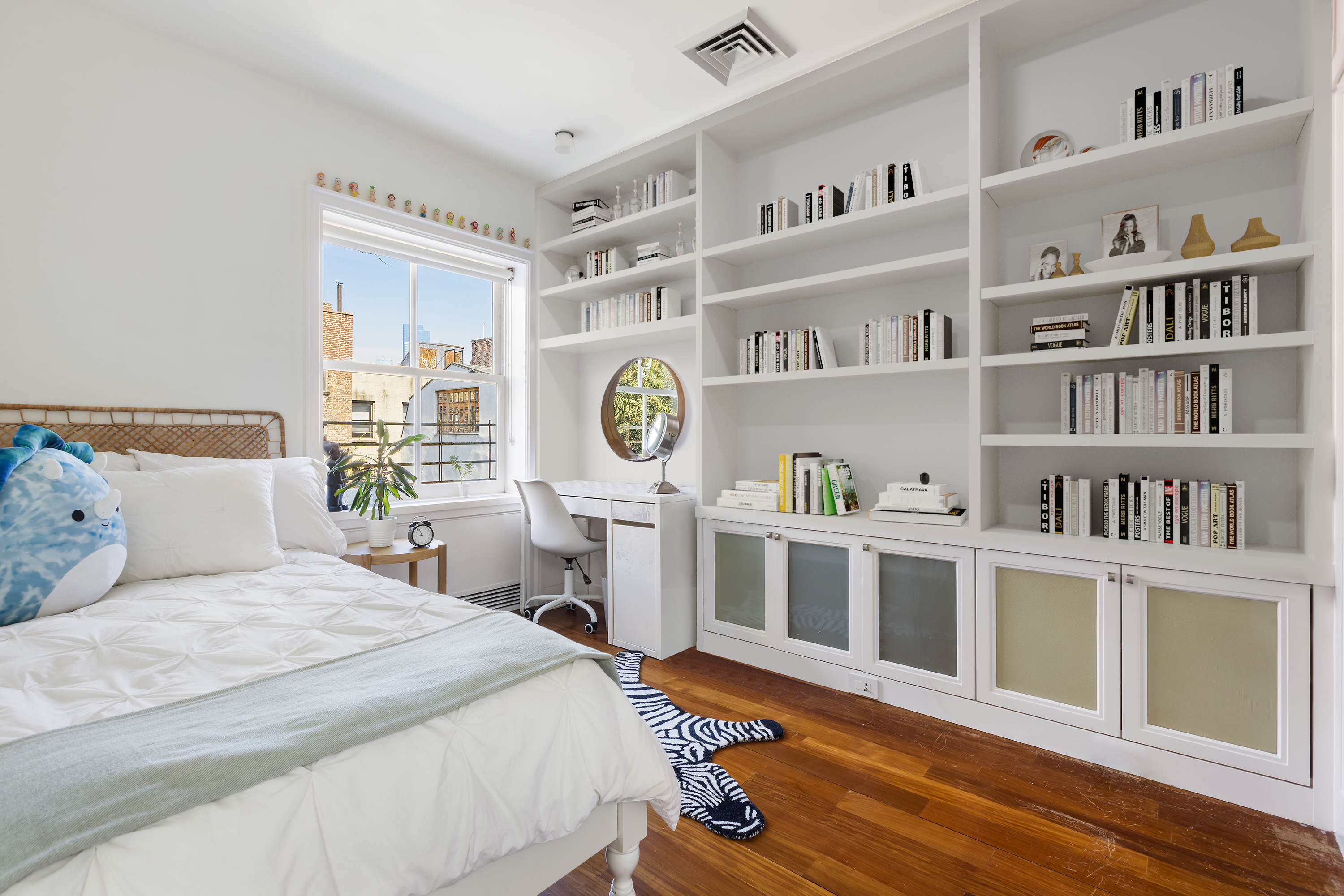 83 Jane Street Manhattan, NY 10014 - Photo 22 of 29 a bedroom with a bed and a book shelf