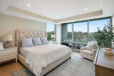 a large bedroom with a large bed and a large window