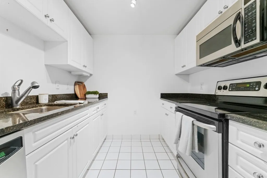 a kitchen with stainless steel appliances granite countertop a sink and cabinets