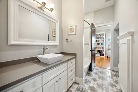 a spacious bathroom with a granite countertop sink and a mirror