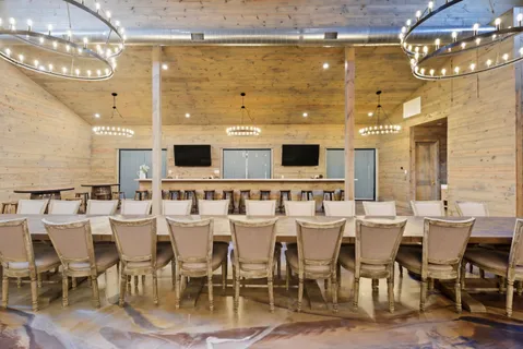 a large kitchen with a table and chairs