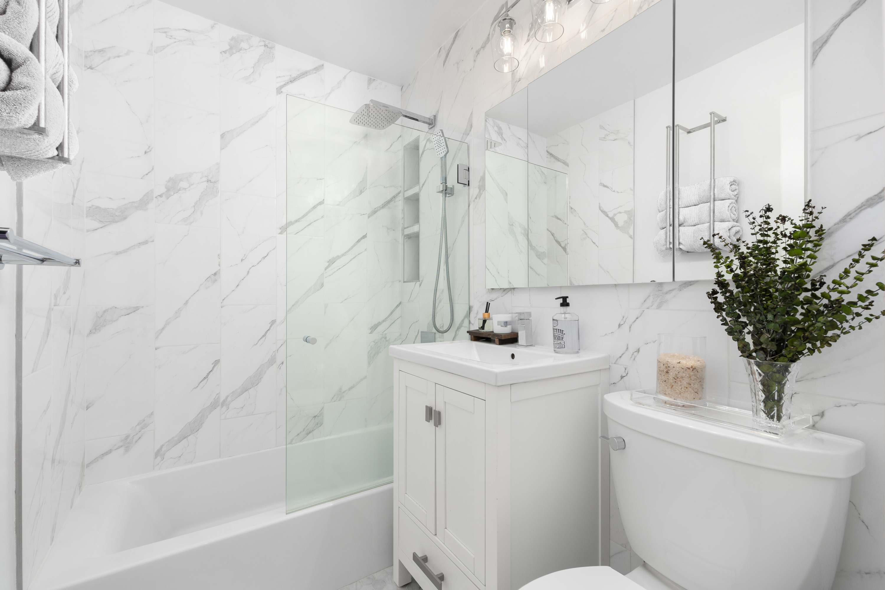 333 East 66th Street, Unit 8C Manhattan, NY 10065 - Photo 9 of 13 a bathroom with a sink a toilet and a bathtub