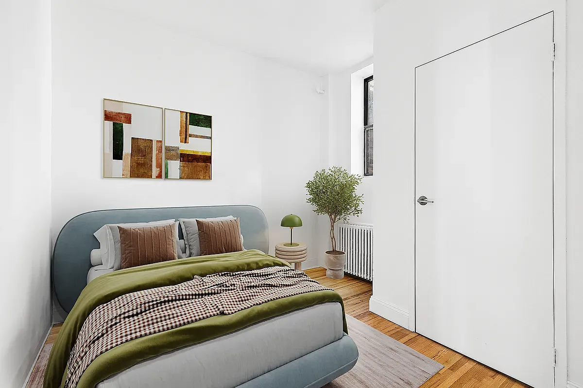 643 9th Avenue, Unit 5A Manhattan, NY 10036 - Photo 4 of 6 a bedroom with a bed and a potted plant