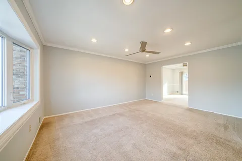 an empty room with windows and closet
