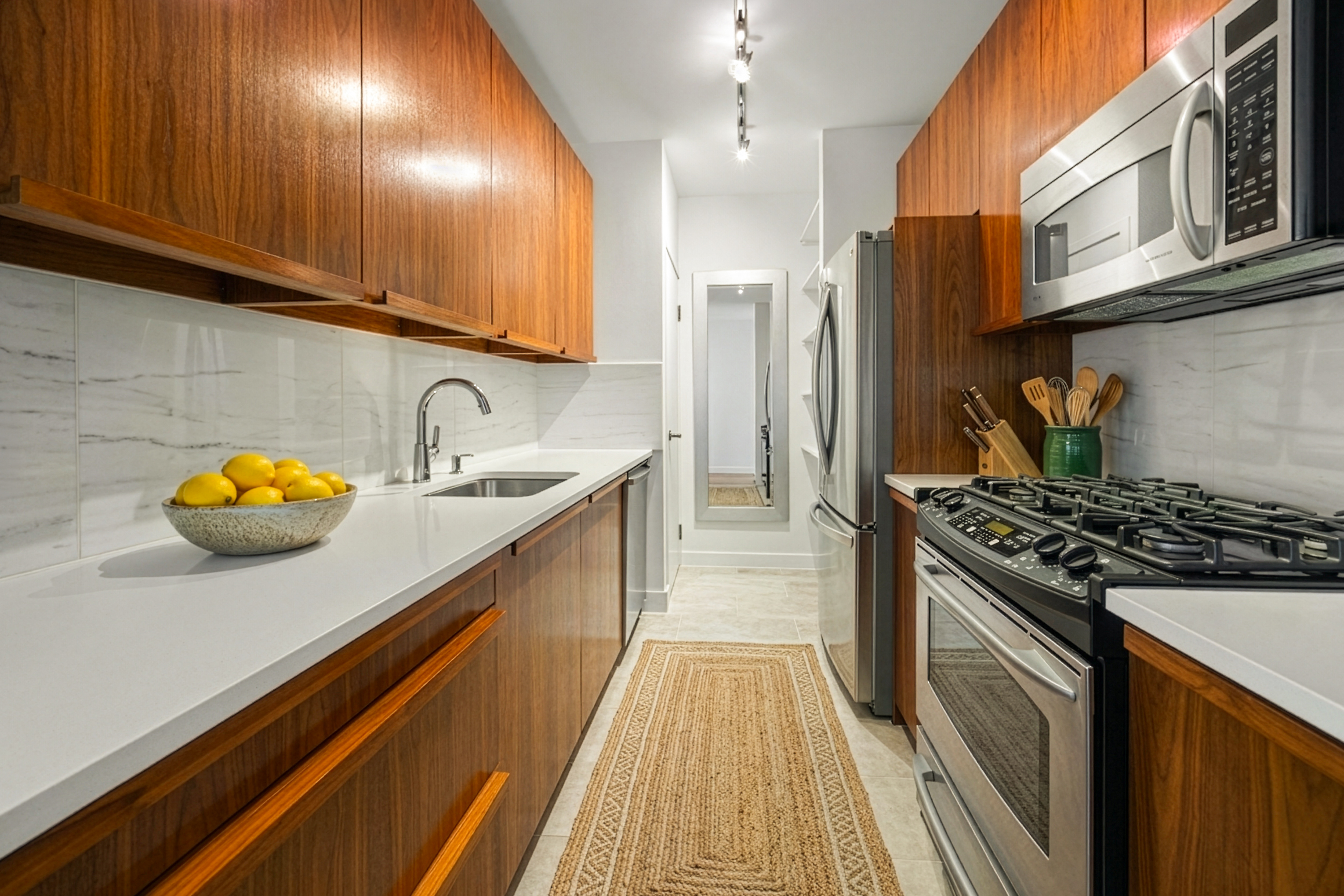 344 West 23rd Street, Unit 2B Manhattan, NY 10011 - Photo 2 of 10 a kitchen with stainless steel appliances granite countertop a sink stove and refrigerator