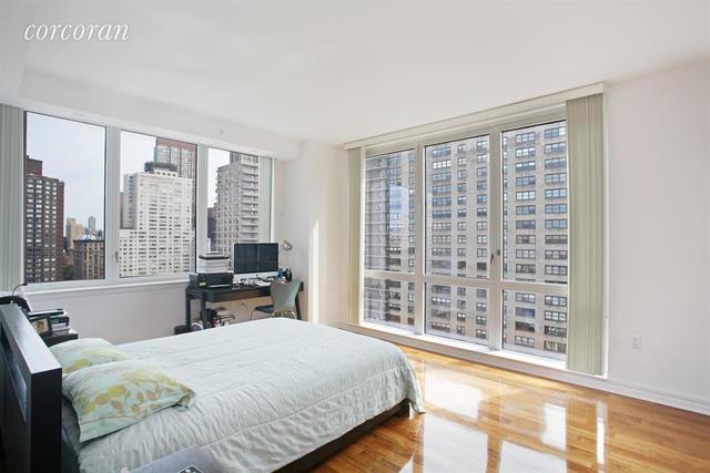 200 West End Avenue, Unit 20A Manhattan, NY 10023 - Photo 3 of 10 a bedroom with a large bed and a large window