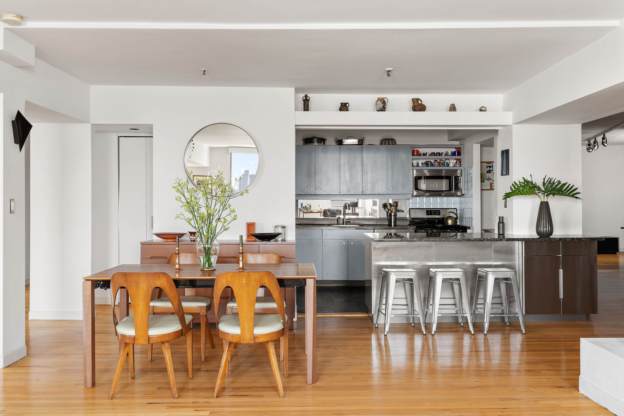 166 Bank Street, Unit 6B Manhattan, NY 10014 - Photo 4 of 16 a dining table with chairs and kitchen view